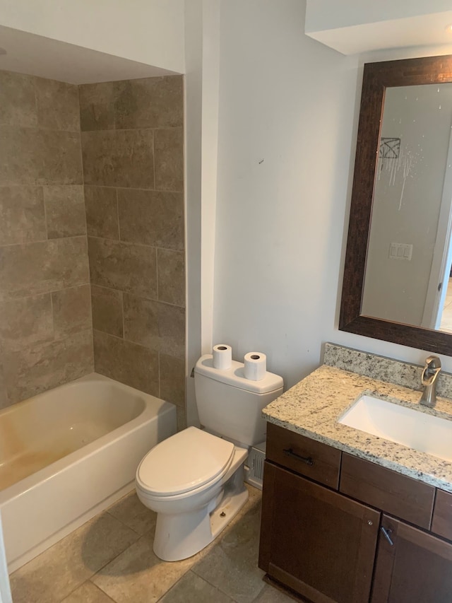 bathroom featuring tile patterned floors, bathing tub / shower combination, toilet, and vanity