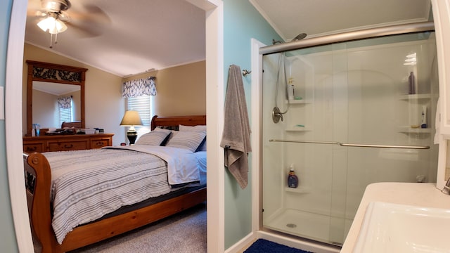 ensuite bathroom with a ceiling fan, lofted ceiling, a stall shower, ornamental molding, and ensuite bathroom