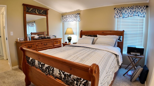 carpeted bedroom featuring baseboards, crown molding, and vaulted ceiling