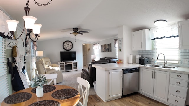 kitchen with ceiling fan, a sink, vaulted ceiling, dishwasher, and open floor plan