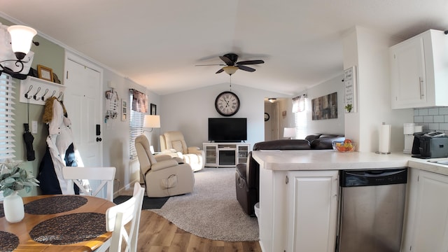 kitchen with open floor plan, white cabinetry, a ceiling fan, and stainless steel dishwasher