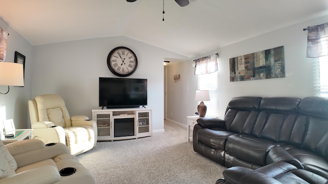 living area featuring baseboards, carpet floors, ceiling fan, and vaulted ceiling