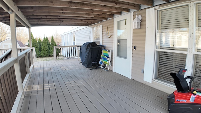 wooden deck with an outbuilding, area for grilling, and a shed