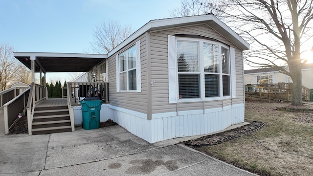 view of property exterior featuring a wooden deck