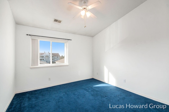 carpeted spare room with a ceiling fan, visible vents, and baseboards