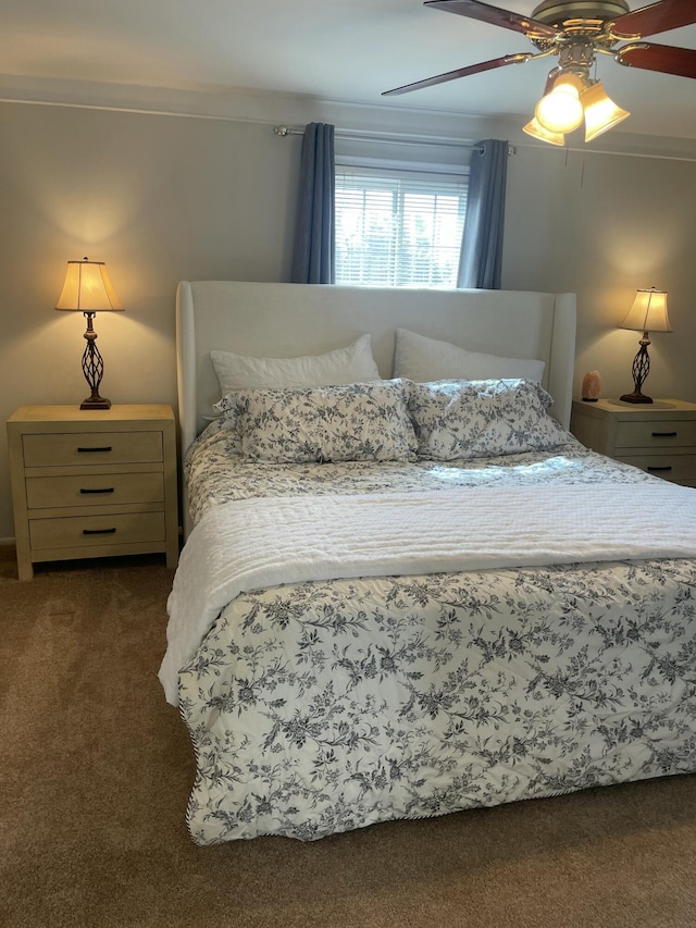 bedroom with a ceiling fan and dark colored carpet