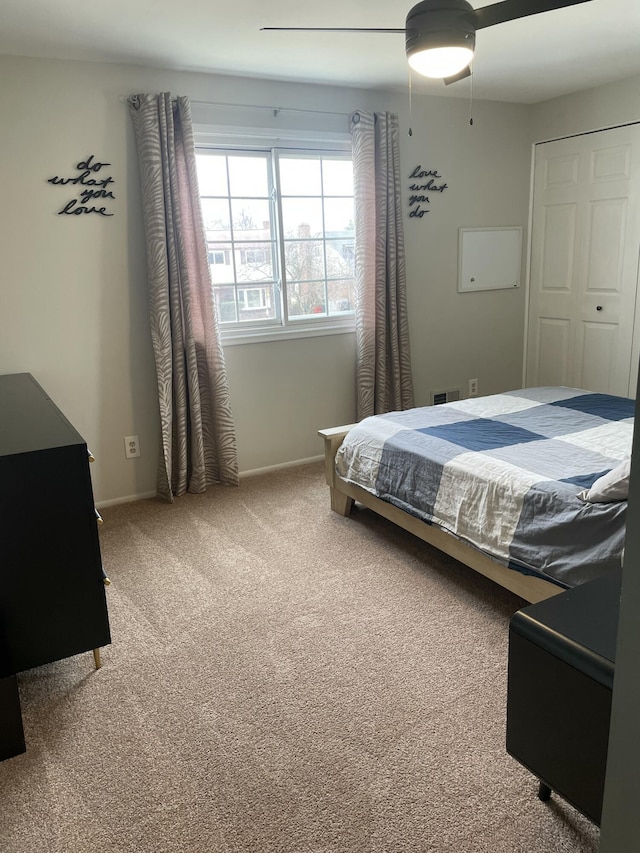 carpeted bedroom with baseboards and a ceiling fan