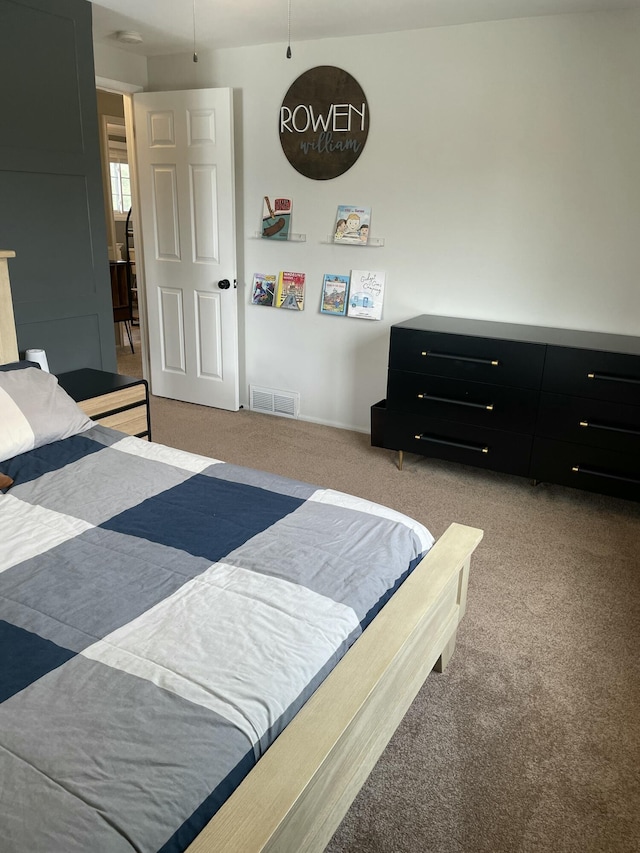 carpeted bedroom featuring visible vents