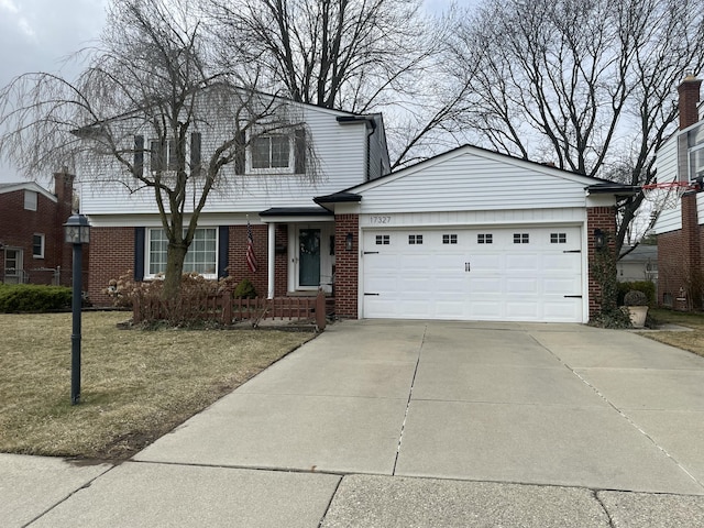 view of front facade with brick siding, driveway, and a garage