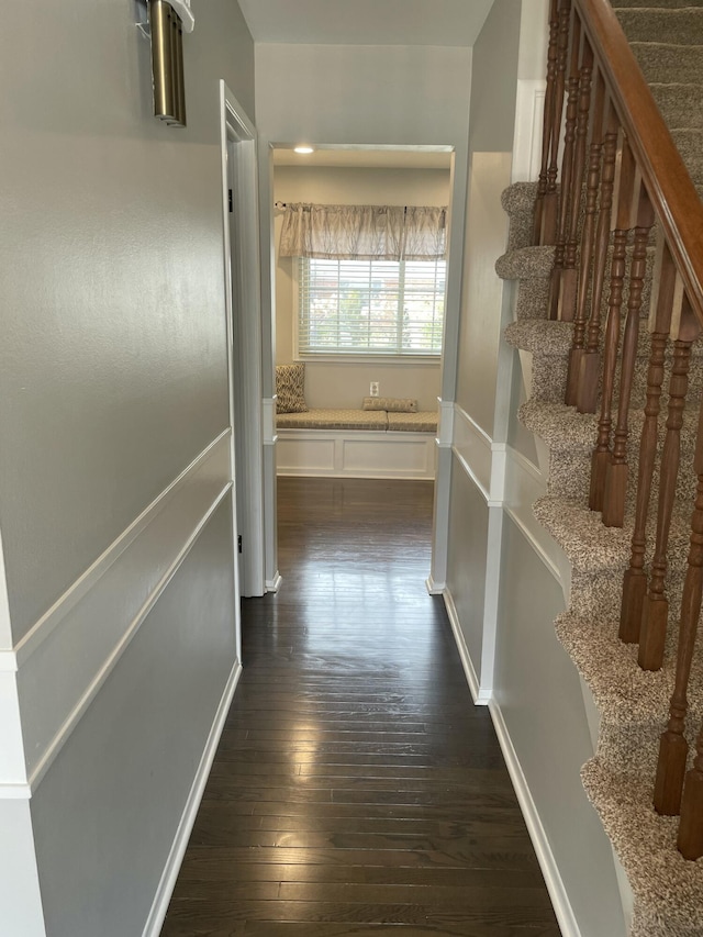 corridor with dark wood-style flooring and stairs