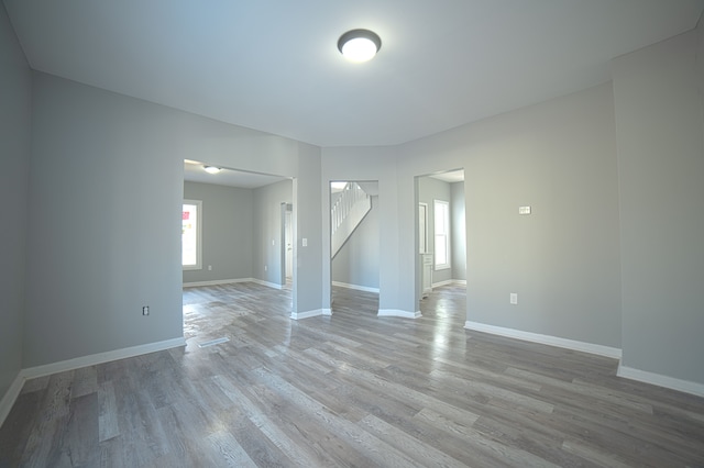 unfurnished room with light wood-style flooring and baseboards