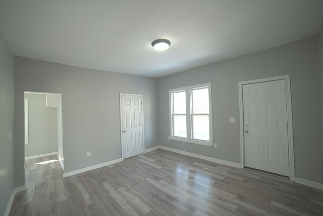 interior space featuring baseboards and wood finished floors