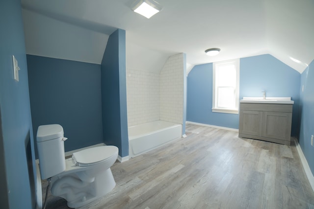 bathroom with toilet, wood finished floors, and baseboards