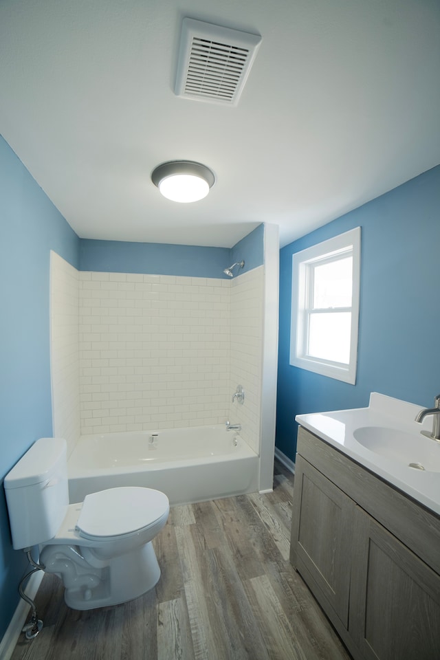 full bathroom with vanity, wood finished floors, visible vents, toilet, and shower / bathtub combination