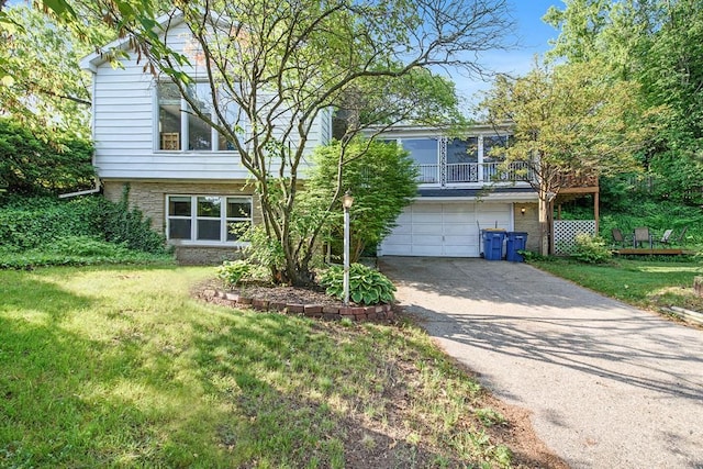 view of front facade featuring a garage, concrete driveway, brick siding, and a front lawn