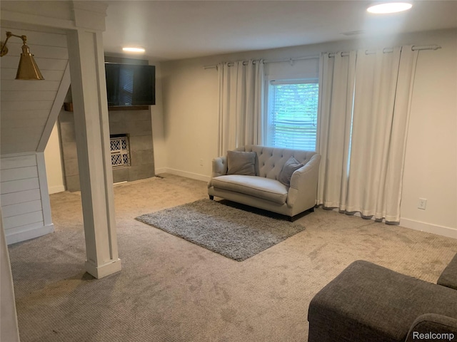 1211 Plymouth Ave SE, Grand Rapids, MI 49506 - carpeted living area with a tiled fireplace and baseboards