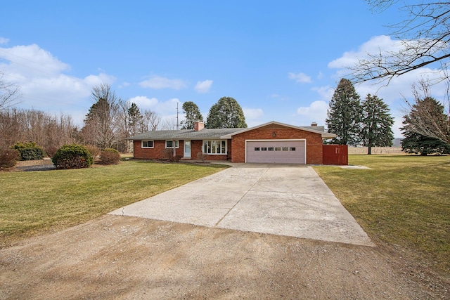 ranch-style house featuring a garage, a chimney, concrete driveway, and a front lawn