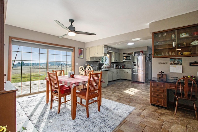 dining space featuring visible vents, stone finish floor, and ceiling fan