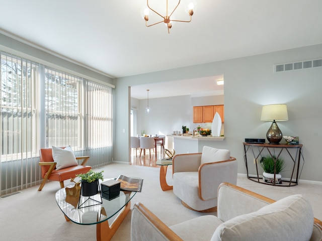 carpeted living room featuring an inviting chandelier, baseboards, and visible vents