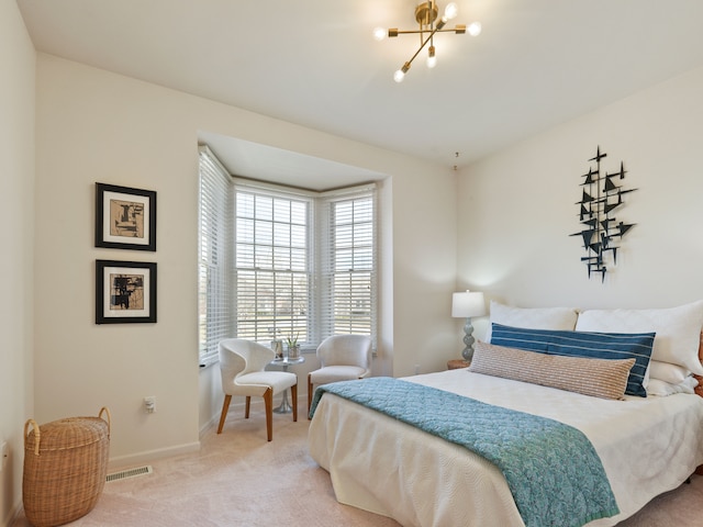 bedroom featuring baseboards, carpet floors, a notable chandelier, and visible vents