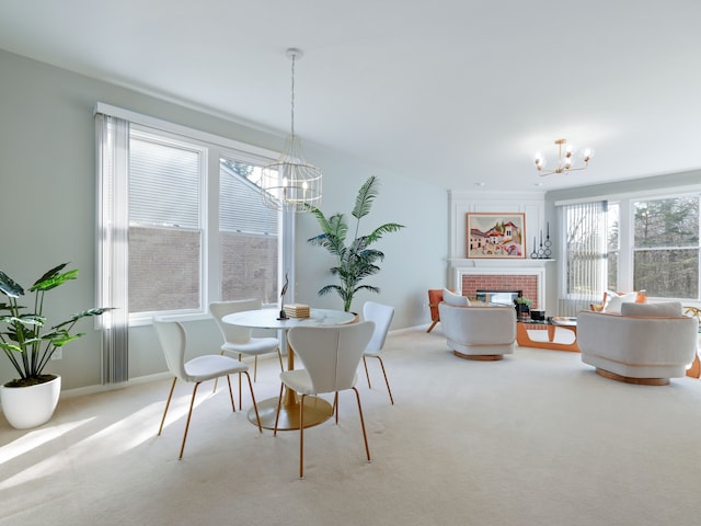 carpeted dining room featuring baseboards, a notable chandelier, and a fireplace