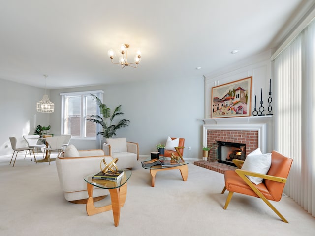 carpeted living room with baseboards, a brick fireplace, and an inviting chandelier