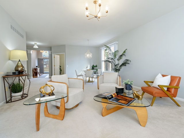 living room with visible vents, an inviting chandelier, baseboards, and carpet