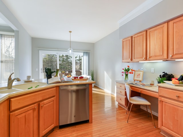 kitchen with a sink, light wood finished floors, dishwasher, light countertops, and built in study area