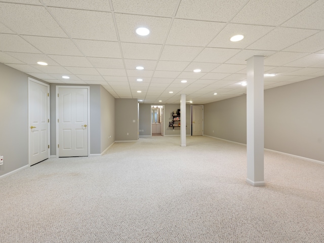 finished below grade area with light colored carpet, recessed lighting, and baseboards