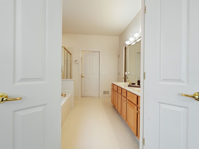 full bathroom featuring double vanity, visible vents, a shower with shower door, and a bathtub