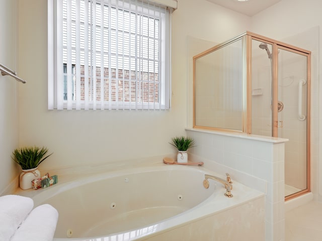 full bathroom featuring a shower stall and a whirlpool tub