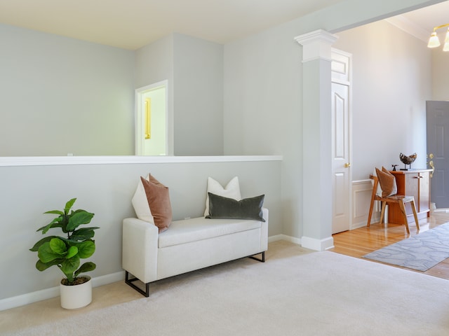 sitting room featuring crown molding, carpet, and baseboards