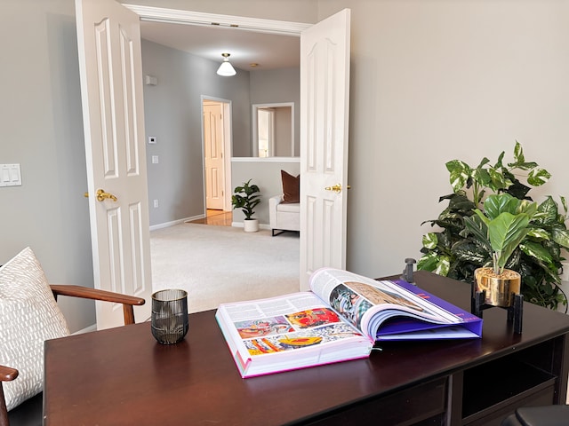 carpeted office space with baseboards