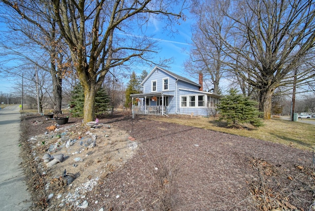 view of front of property with covered porch and a chimney