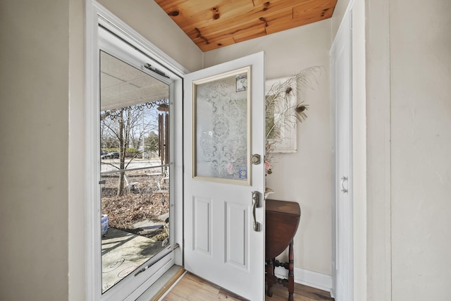 entryway featuring light wood-type flooring and wood ceiling