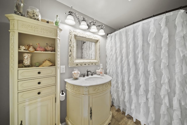 full bath featuring vanity and wood finished floors