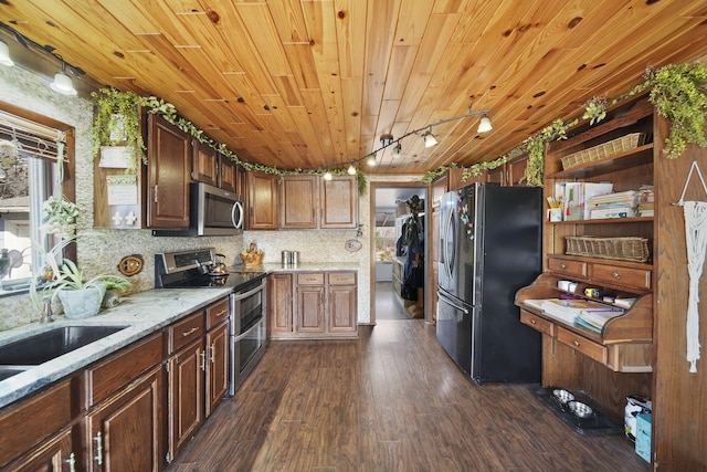 kitchen featuring wood ceiling, rail lighting, dark wood-type flooring, light stone countertops, and appliances with stainless steel finishes