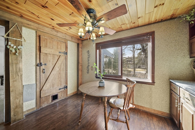 dining room featuring wooden ceiling, dark wood-style flooring, baseboards, and ceiling fan
