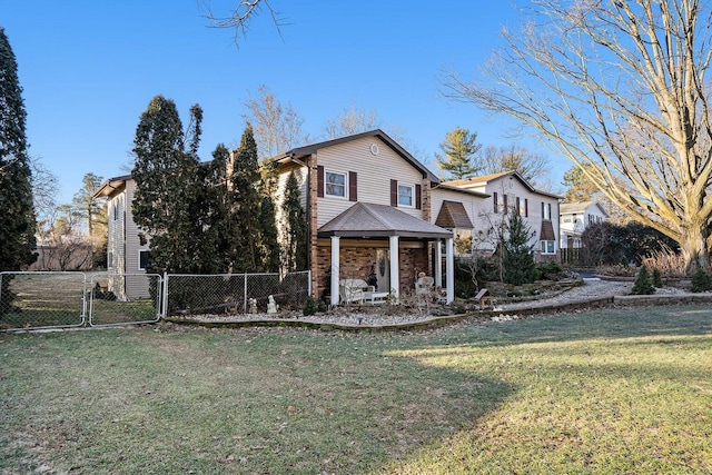 traditional home featuring fence, a front lawn, and a gate