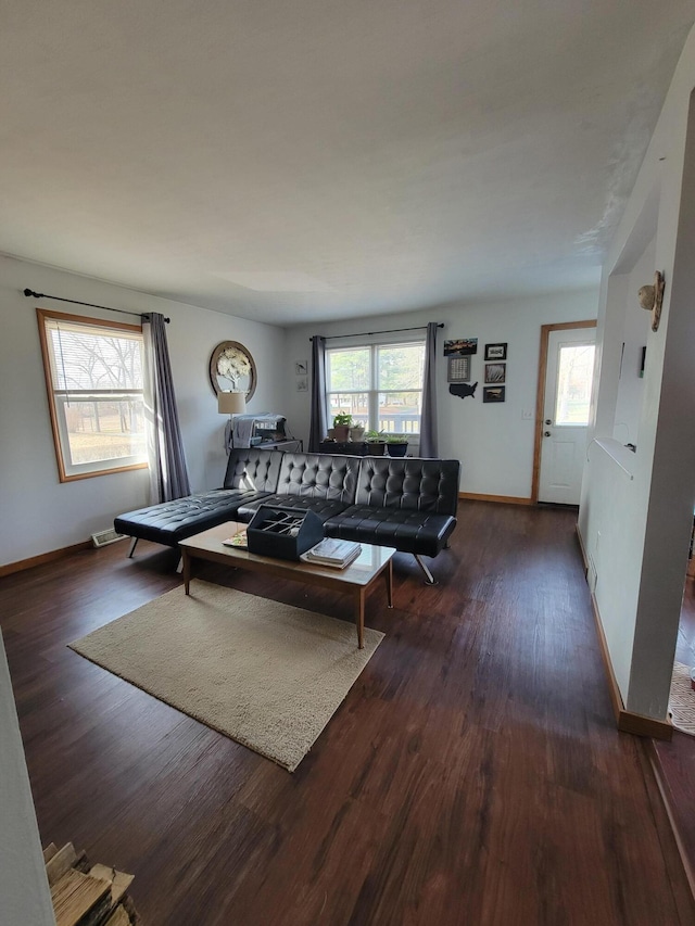 living room featuring baseboards and wood finished floors