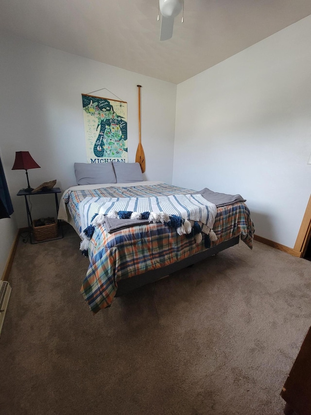 bedroom with a ceiling fan, baseboards, and carpet floors