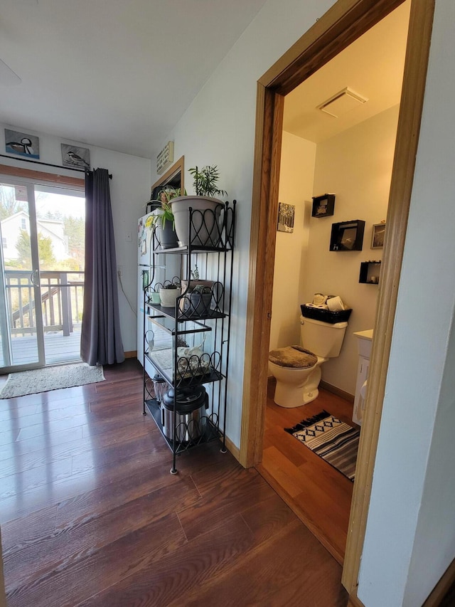 interior space featuring wood finished floors, visible vents, and baseboards