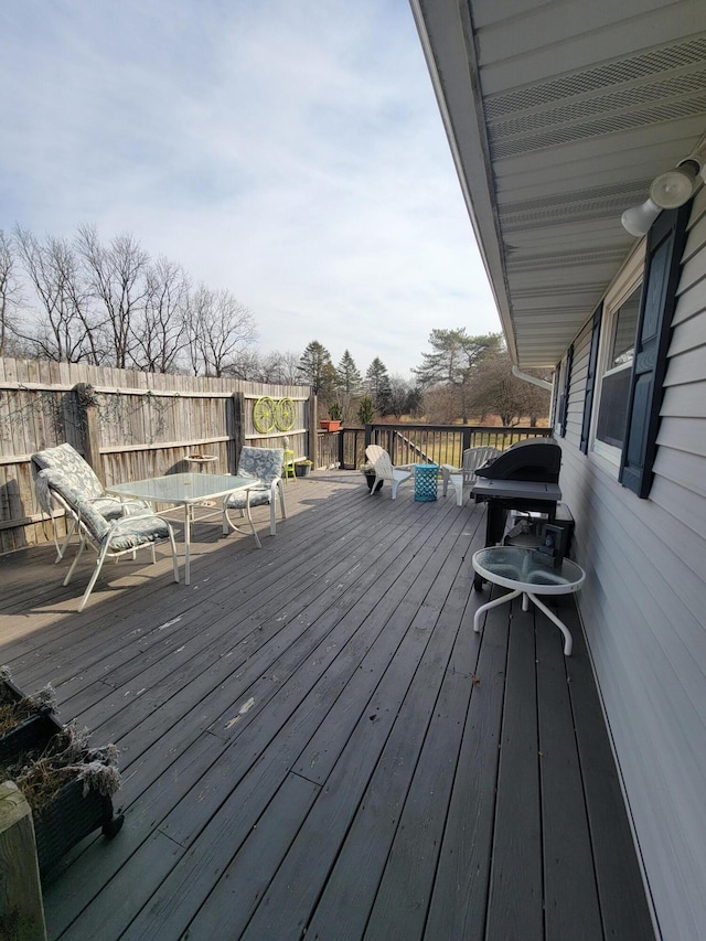 wooden terrace featuring fence