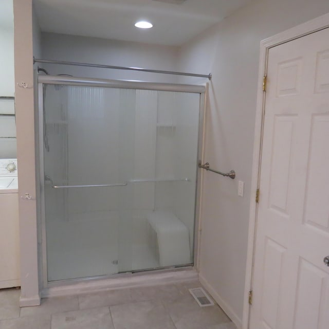 bathroom featuring visible vents, washer / dryer, recessed lighting, a stall shower, and tile patterned floors