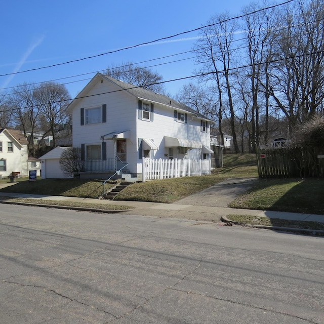 view of front facade featuring a garage and fence