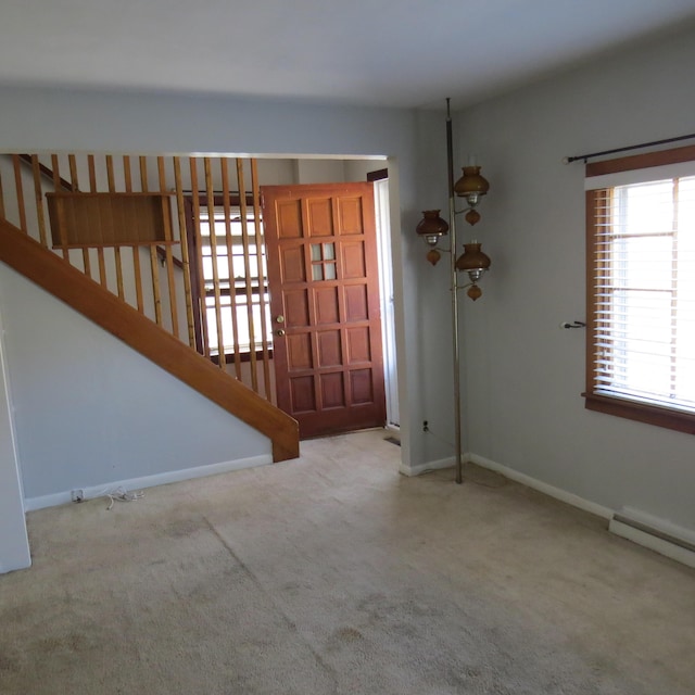 carpeted foyer with baseboards and baseboard heating