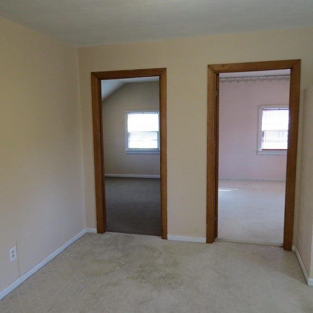 unfurnished room featuring carpet flooring and baseboards