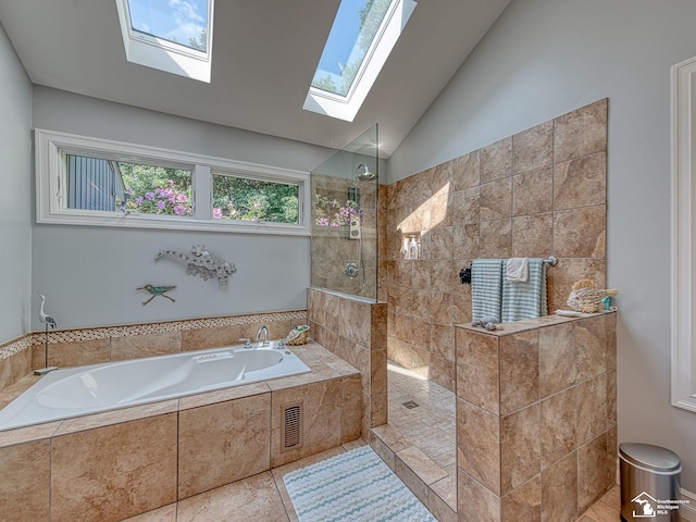 bathroom with lofted ceiling with skylight, visible vents, walk in shower, and a garden tub