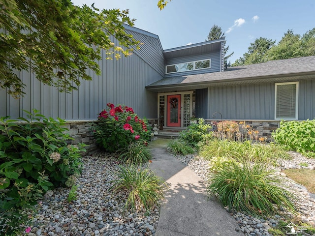 entrance to property featuring stone siding