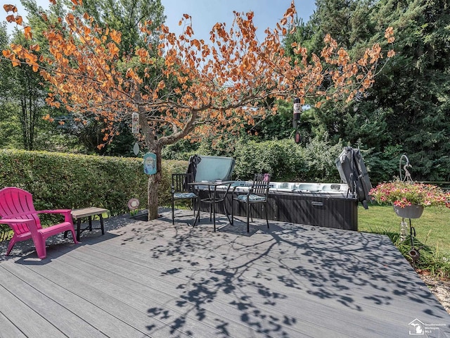 wooden deck featuring a hot tub